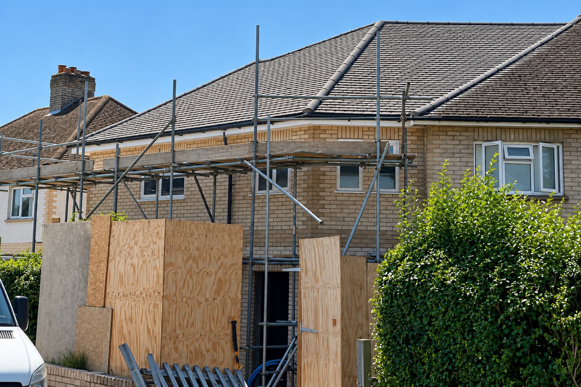 The two new build homes in Egham under construction, with scaffolding to the front elevation