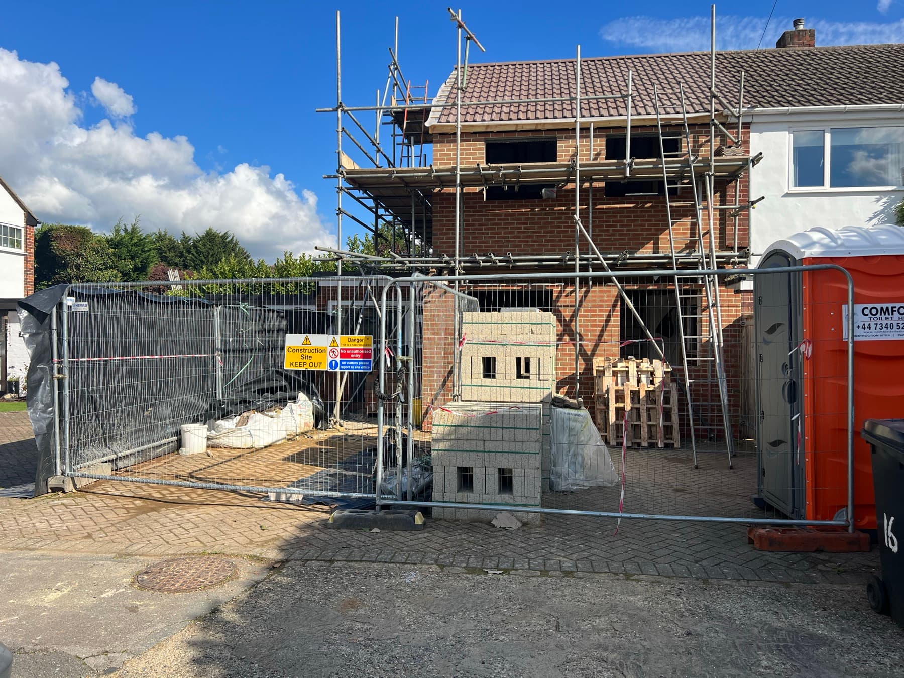 Completed double storey side extension in Gerrards Cross, viewed from the street with scaffolding still in place