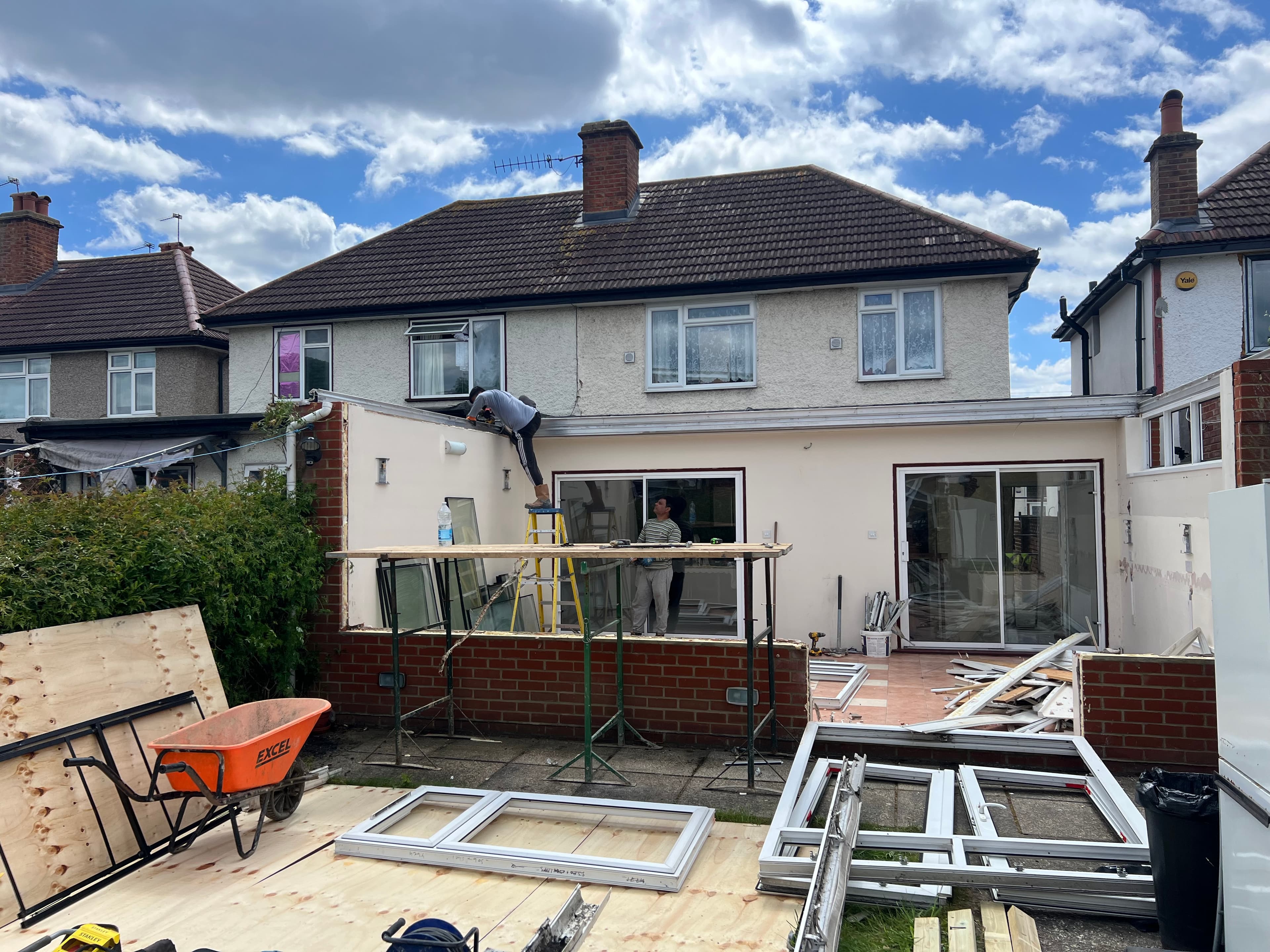 Rear elevation of the Hounslow property during construction of the single storey extension, with window and door frames being fitted