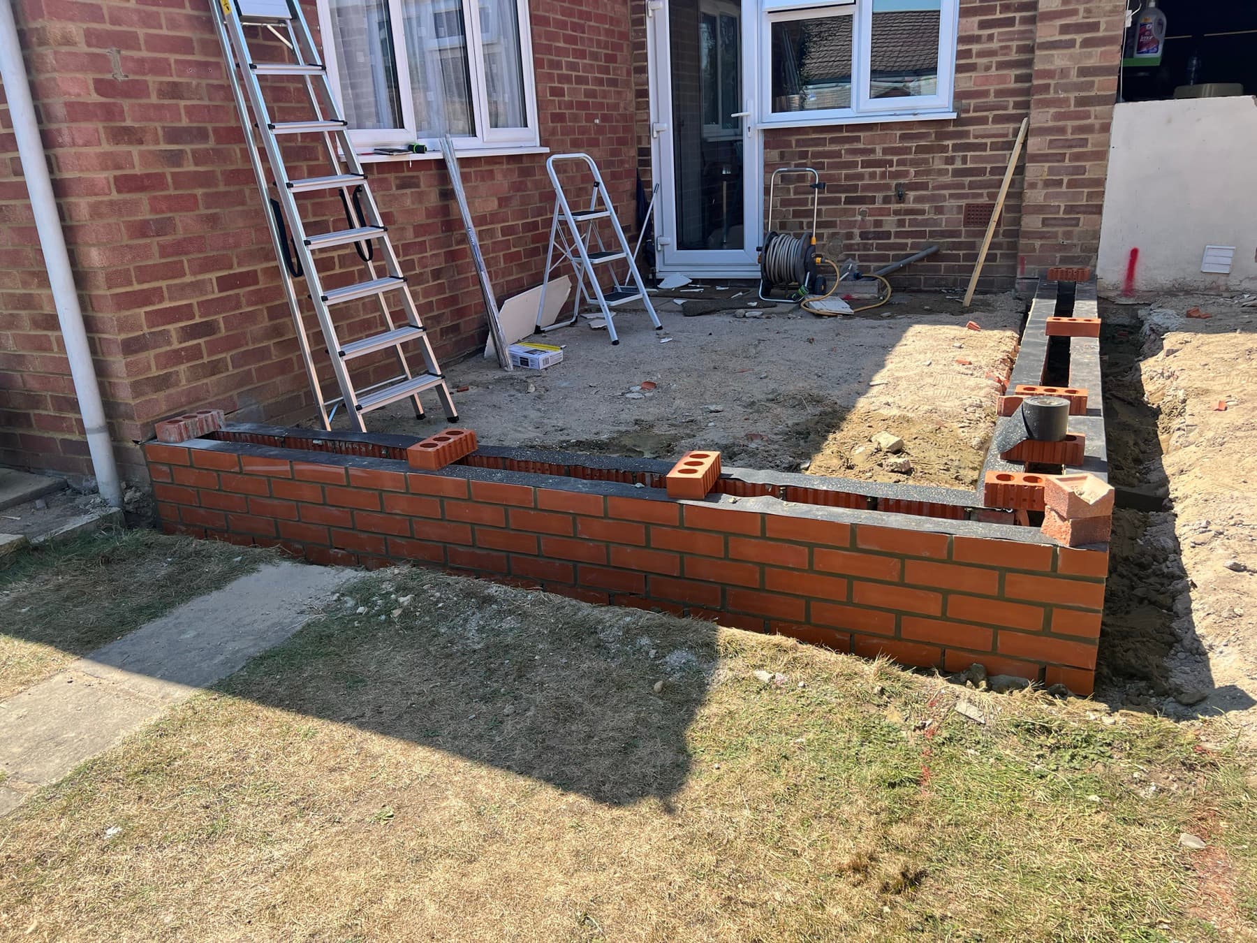 New brickwork to the rear extension built up to damp-proof course level