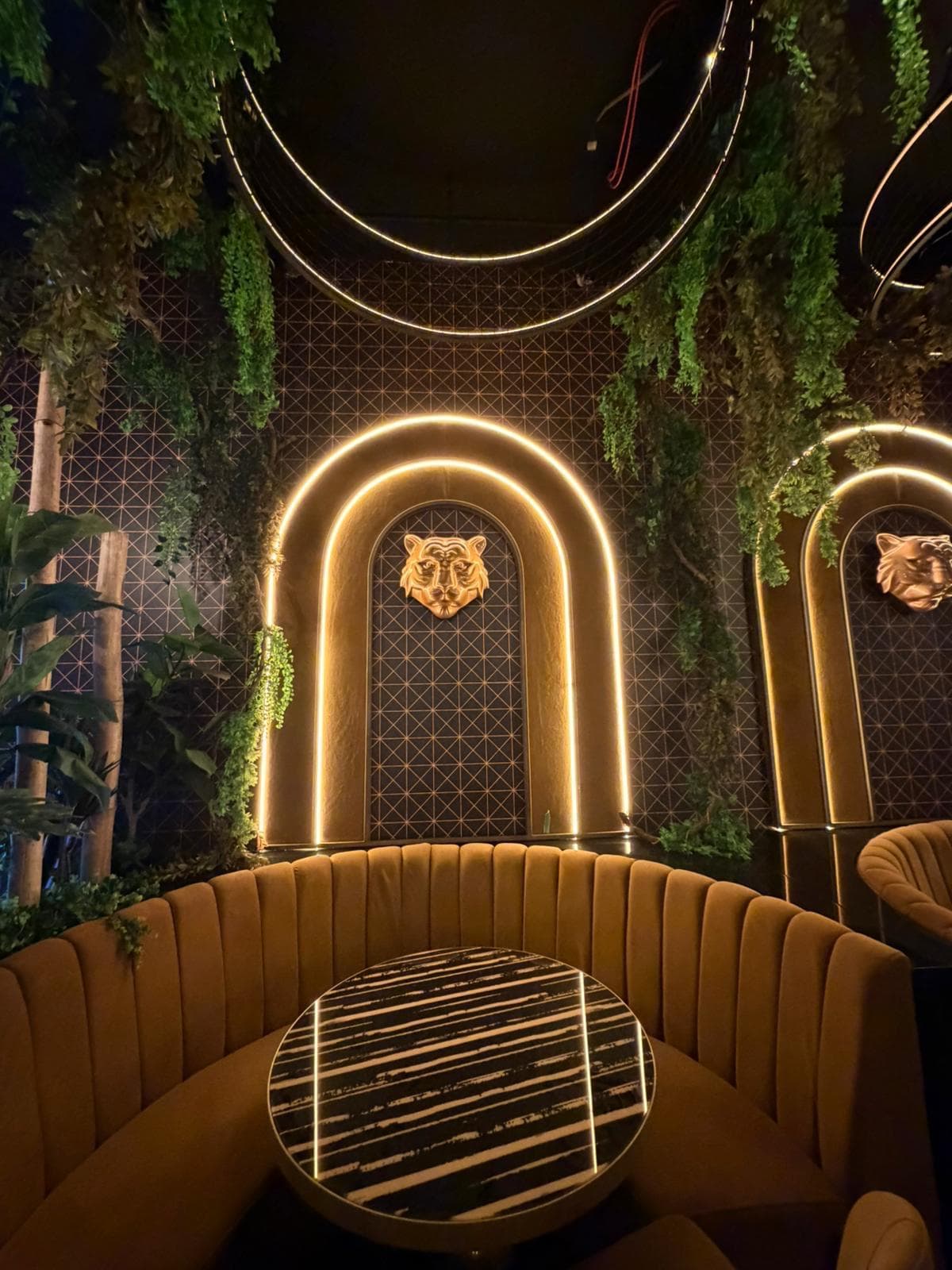 Completed booth seating nook beneath a gold arch, detail view