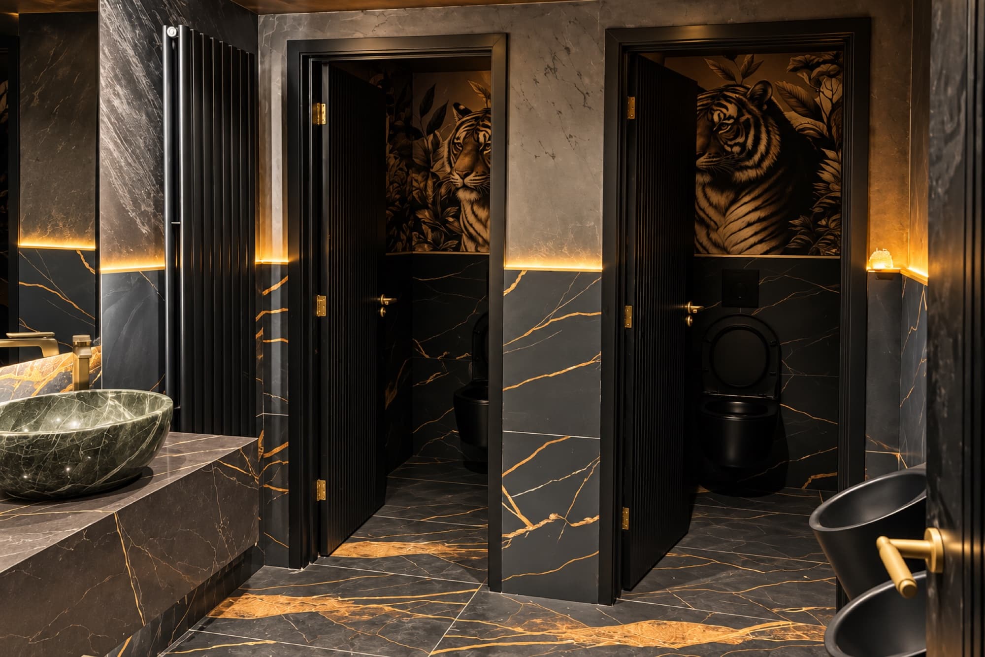 Tiger-mural washroom cubicles with marble tiling and brass fittings