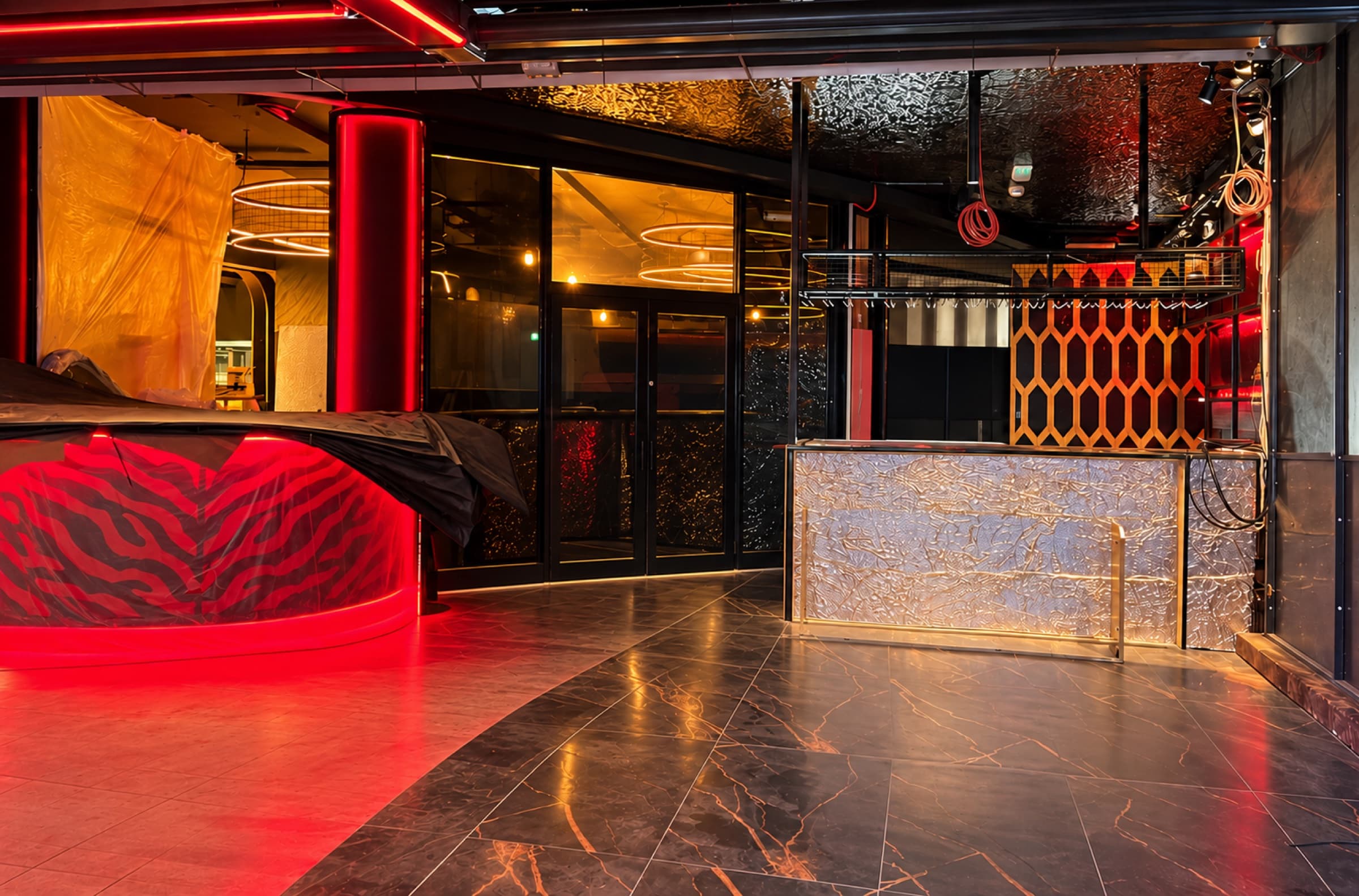 Bar and lounge area fit-out with neon lighting and a marble-topped bar