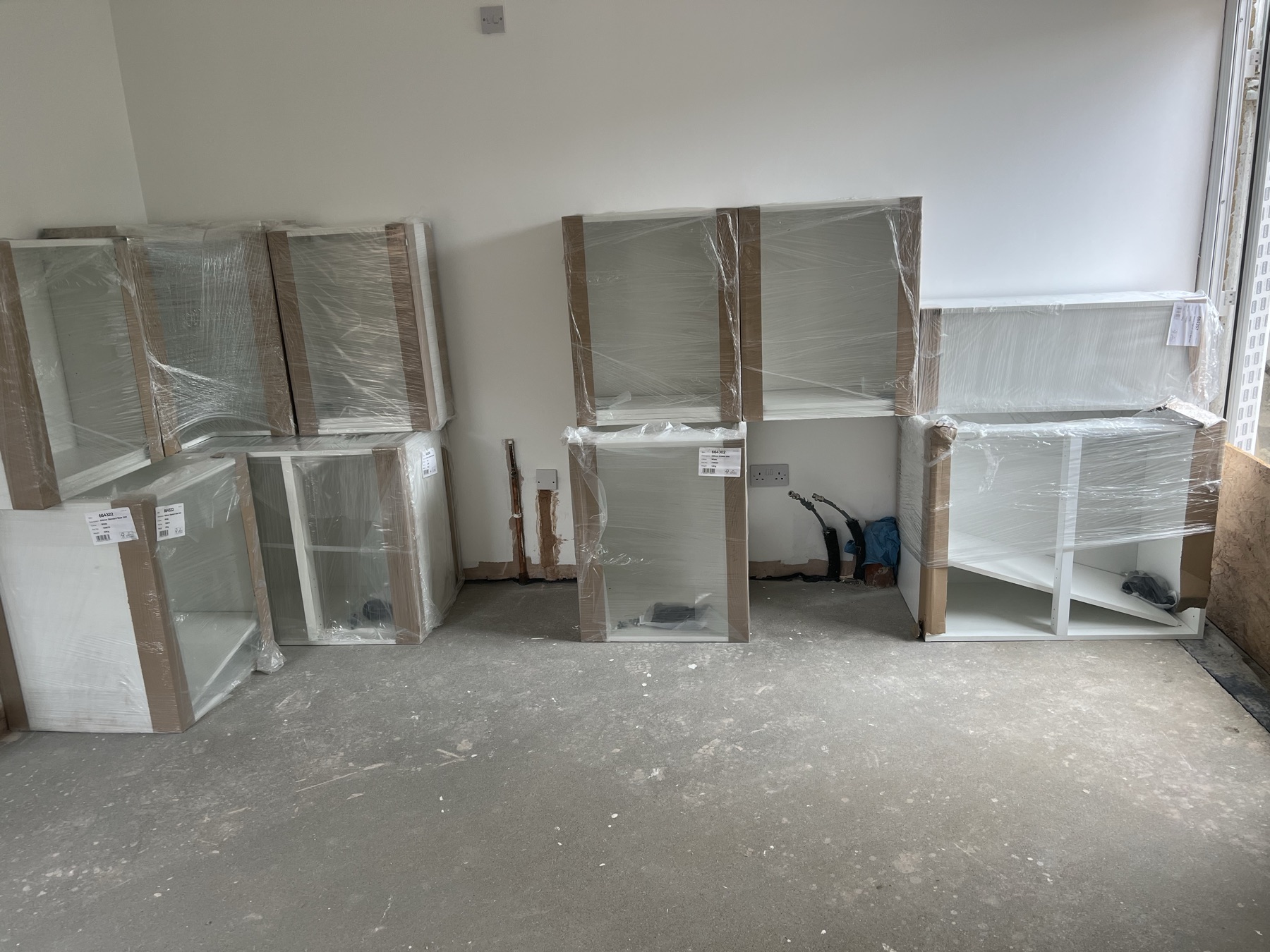 Flat-pack kitchen units staged ready for installation
