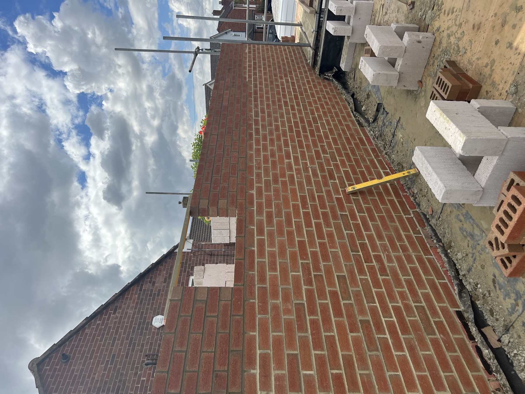 New brickwork to the side extension with blockwork and insulation stacked ready for the next lift