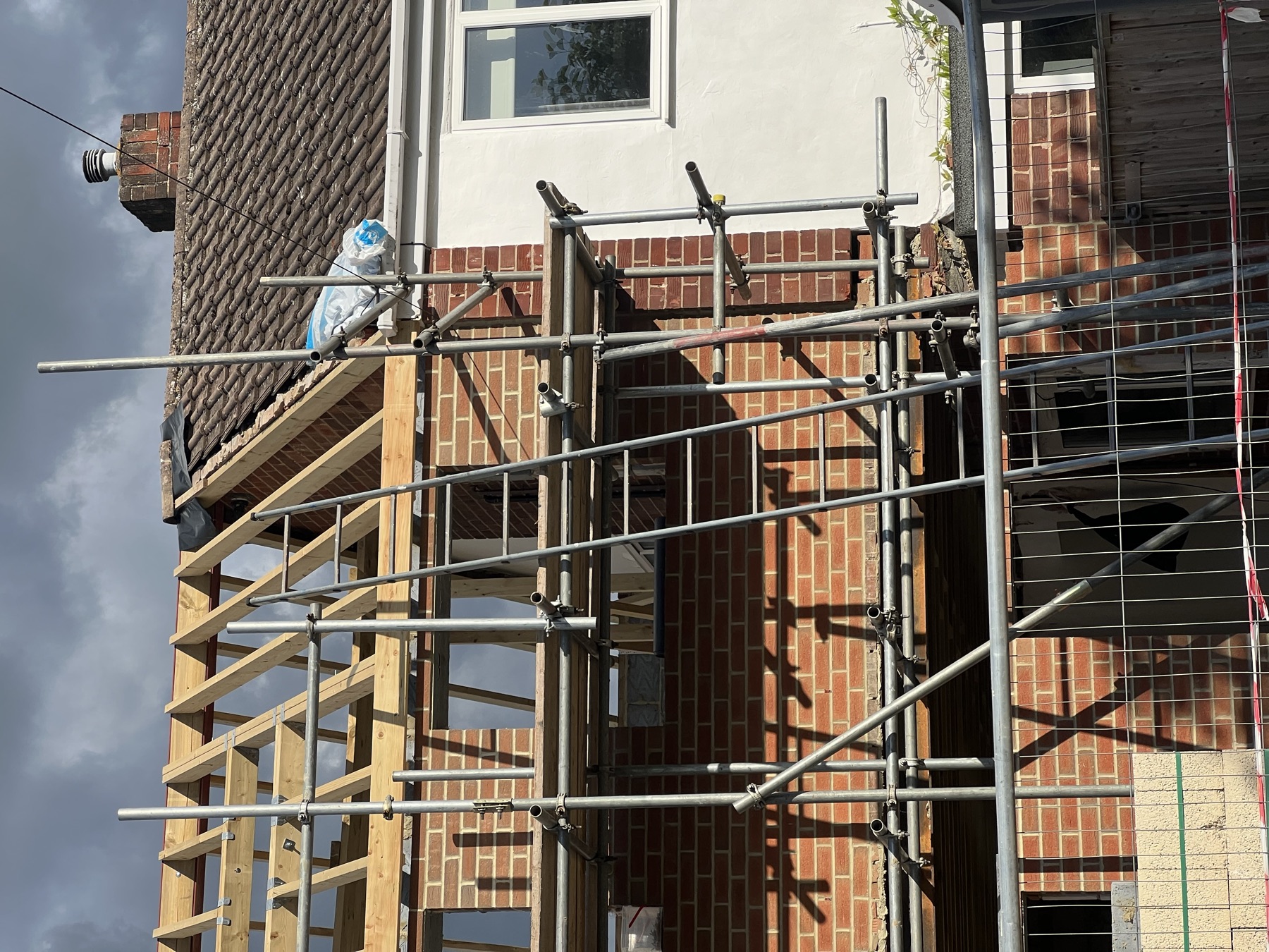Scaffolding and timber wall plate in place ahead of the first floor brickwork