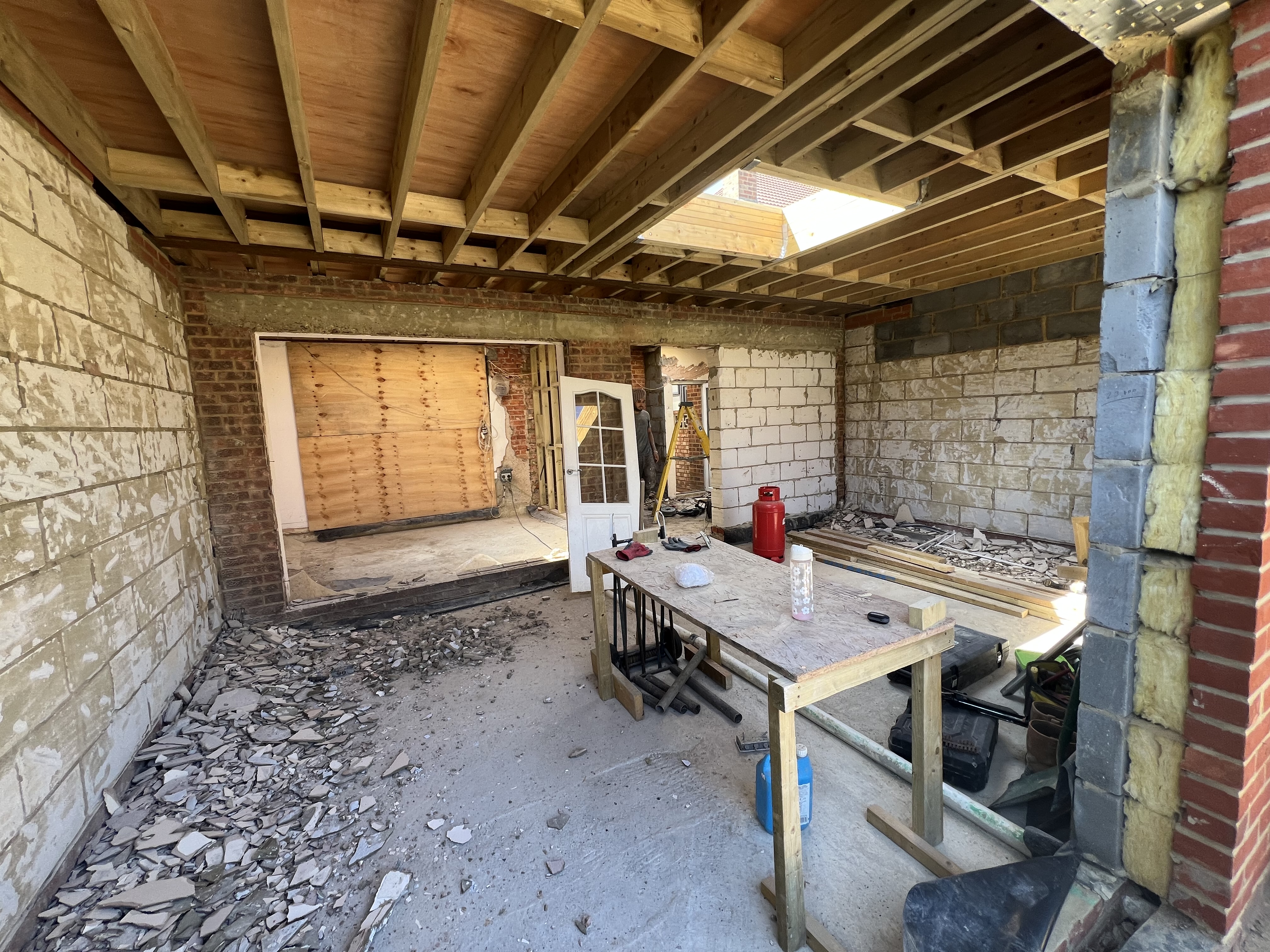 Exposed roof joists and blockwork during the internal strip-out and rebuild