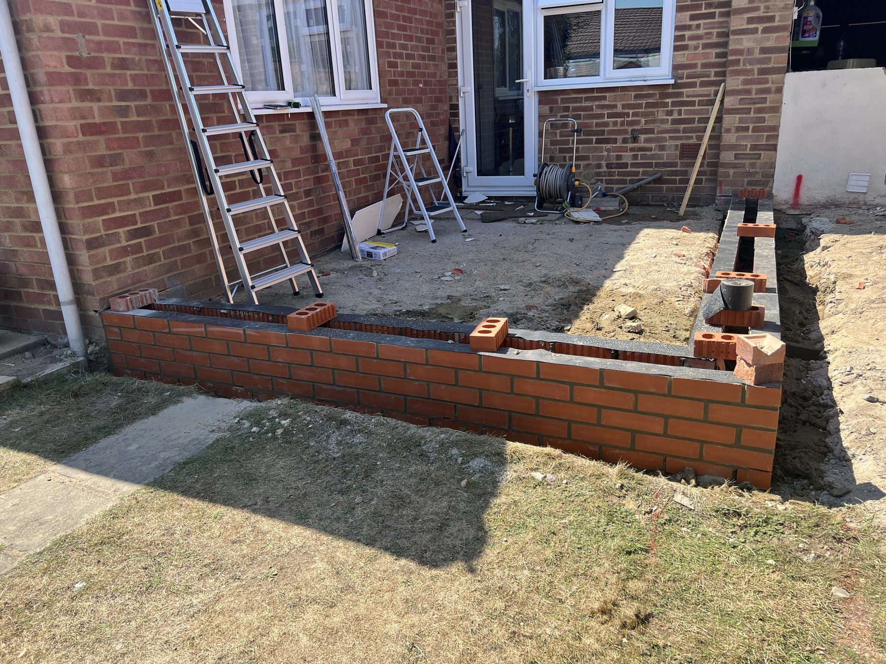 New brickwork to the rear extension built up to damp-proof course level