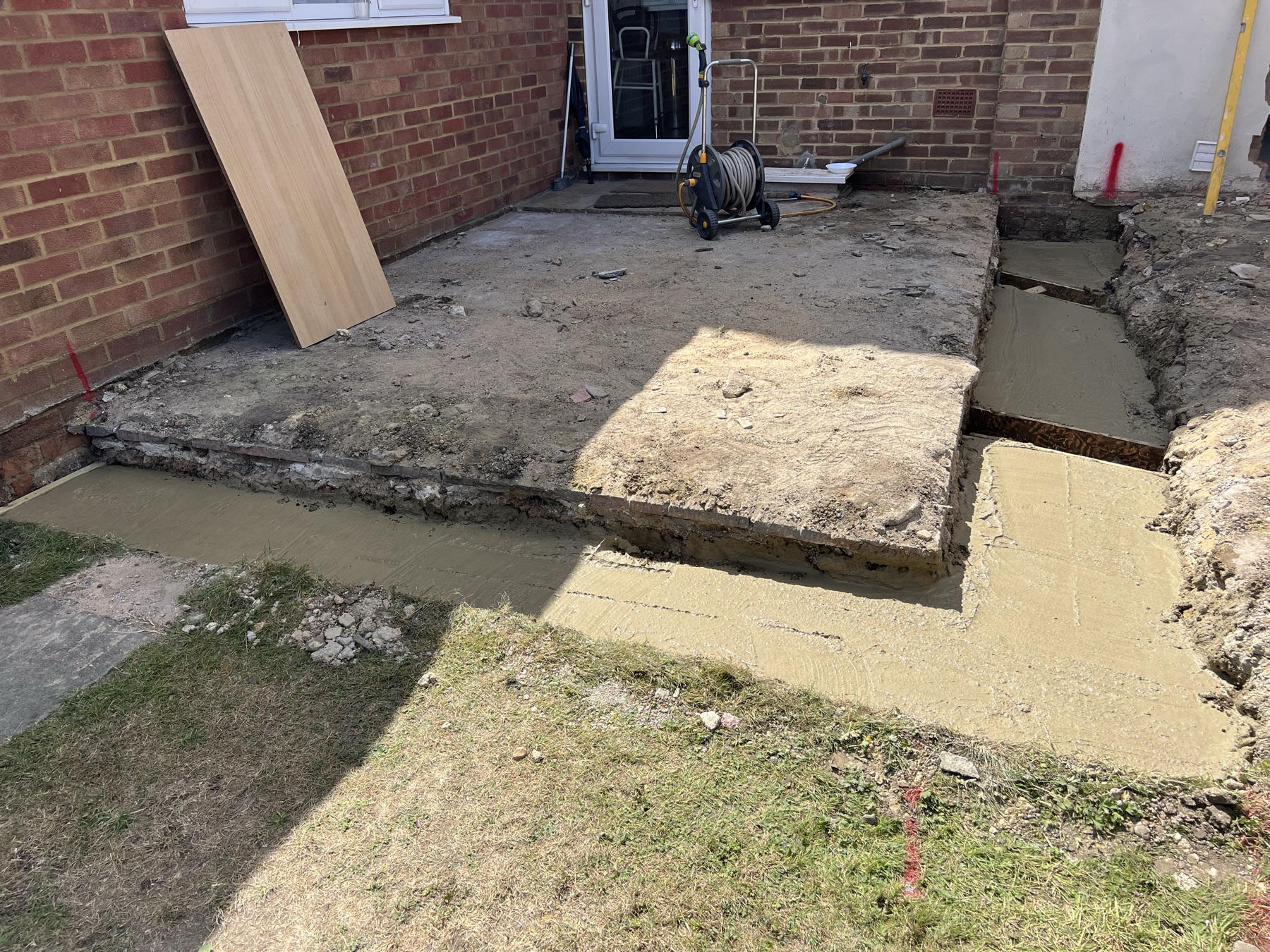 Existing elevation with the new structural opening into the garage boarded up ahead of the extension works