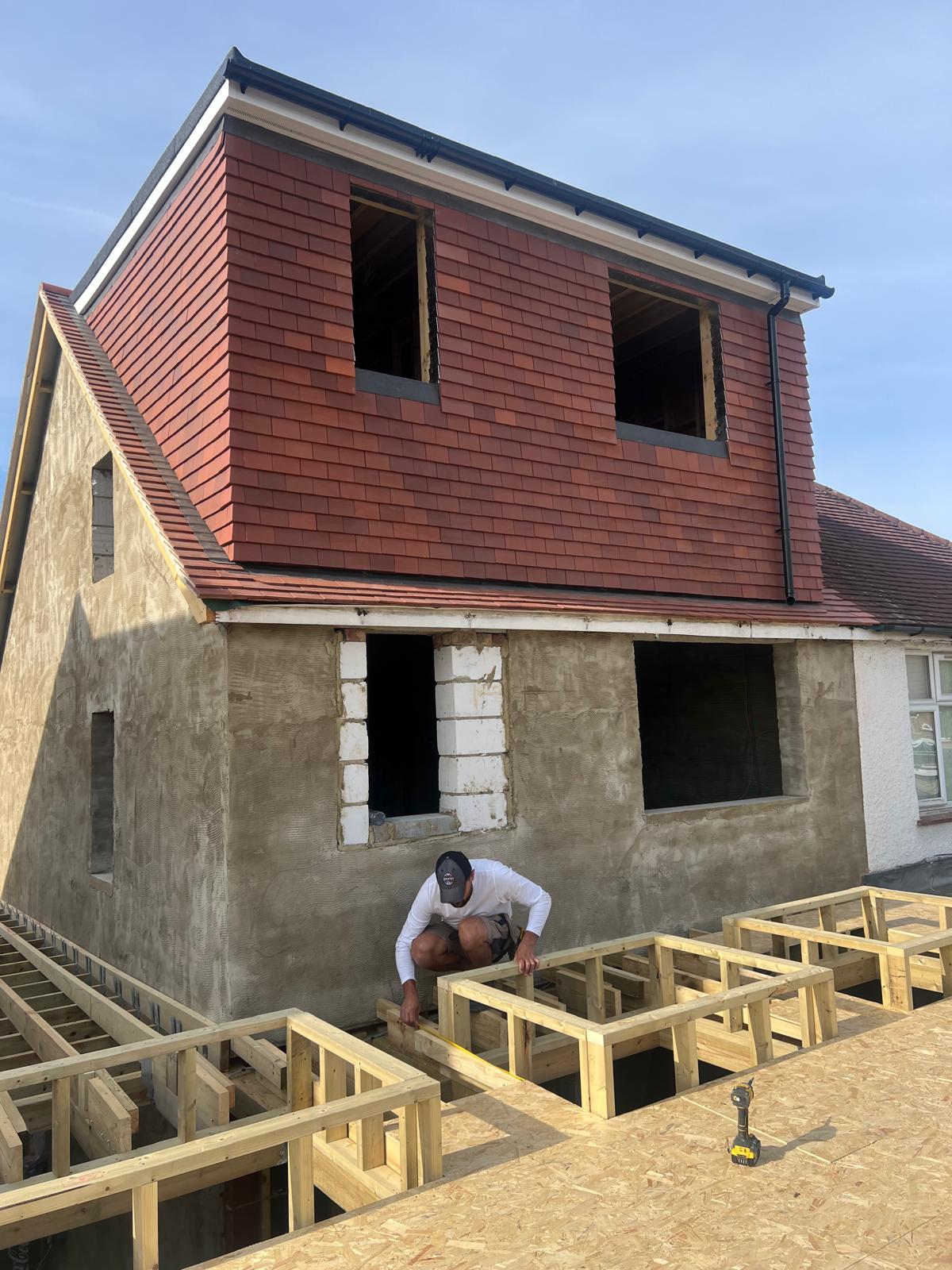Loft dormer conversion with tile cladding complete and roof window openings formed