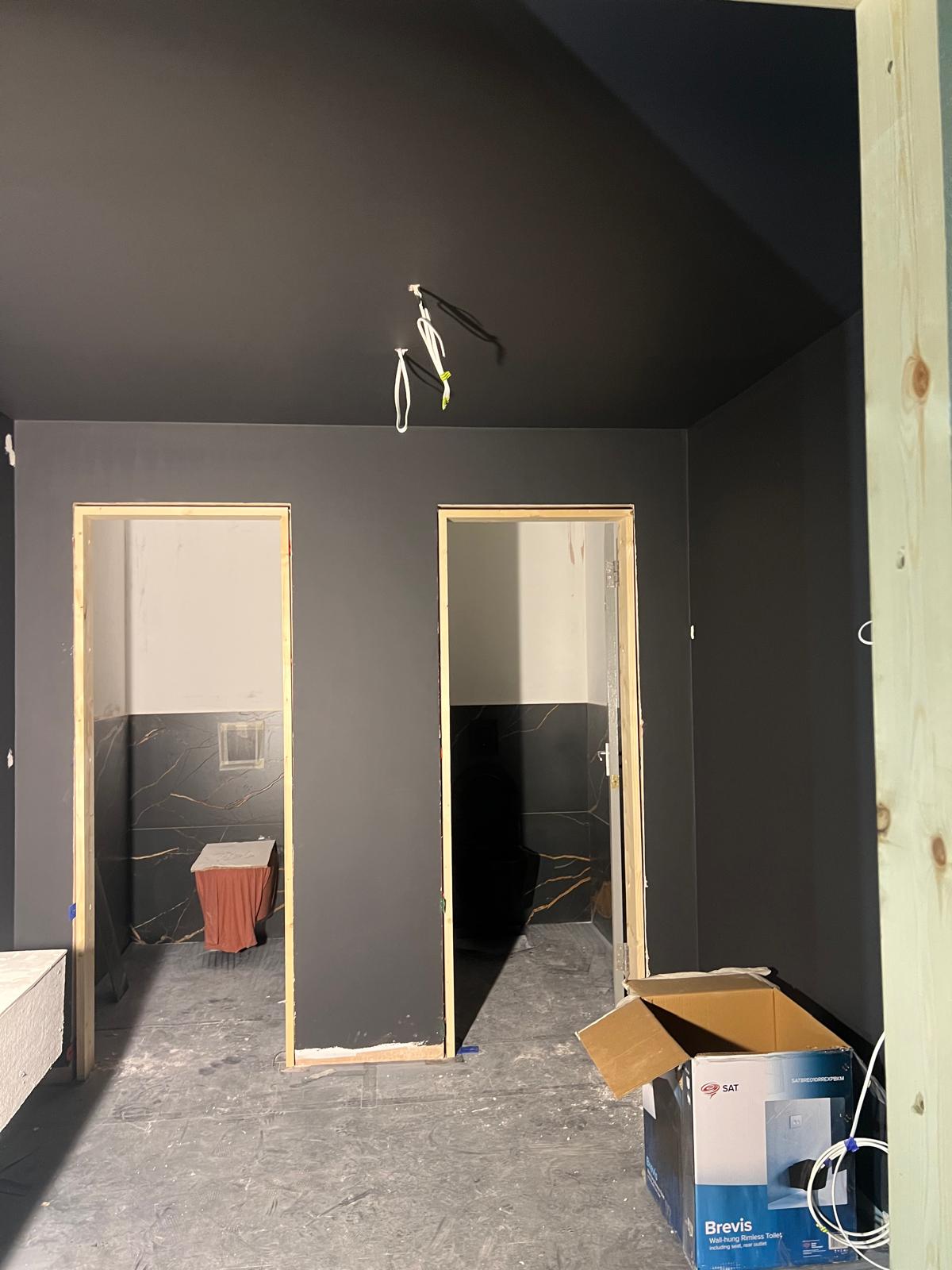 Washroom cubicles under construction, with sanitaryware still boxed