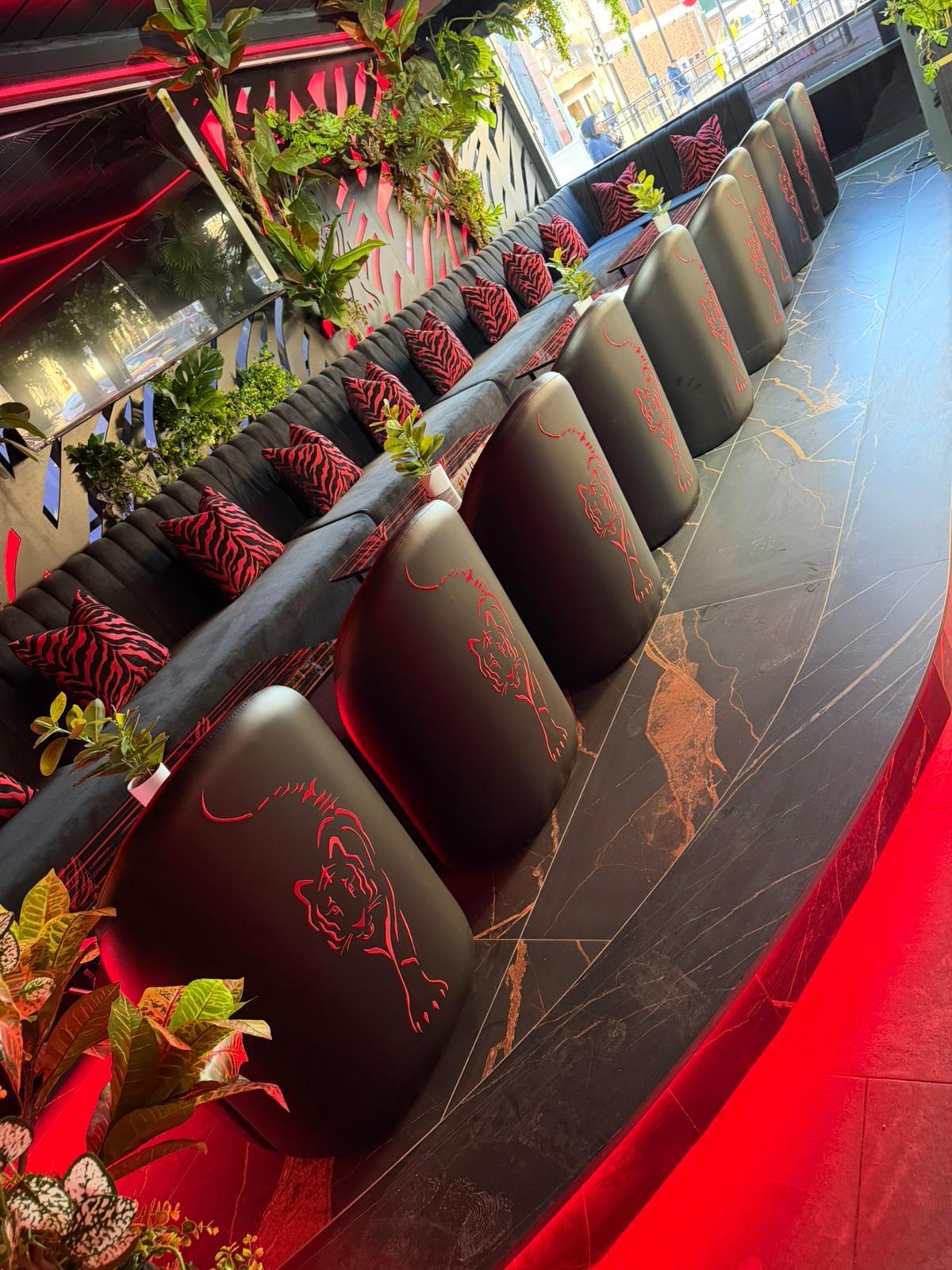Completed booth seating with a tiger emblem stitched into the upholstery