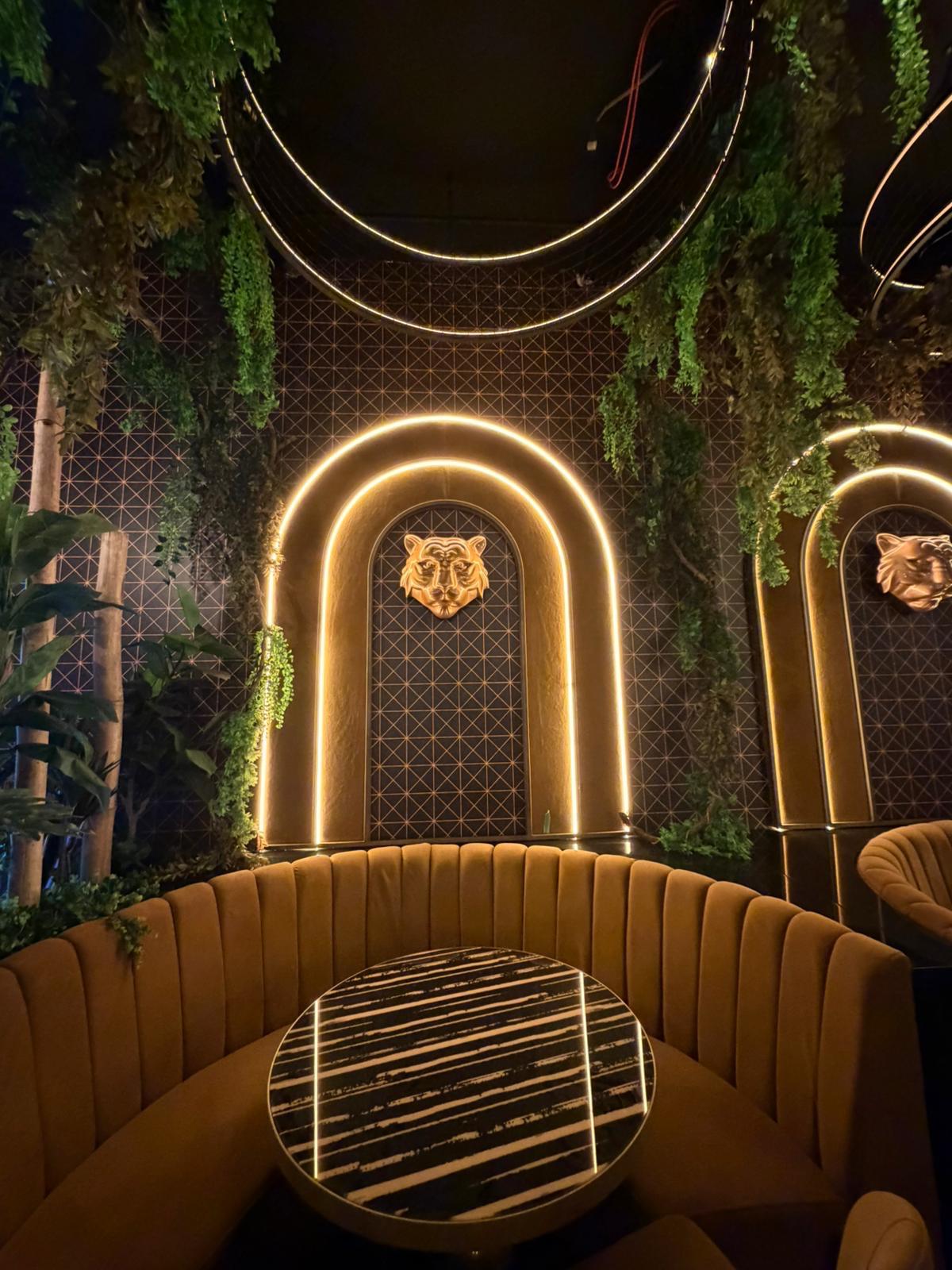 Completed booth seating nook beneath a gold arch, detail view